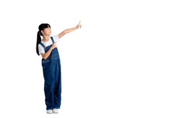 A young girl in denim overalls points with one hand, gazing upwards, full body on PNG 
