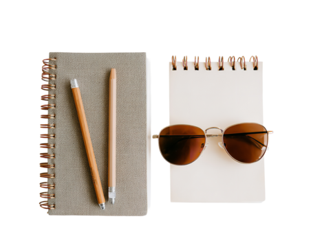 Simple workspace essentials: notebook, pencils, and sunglasses on a clean white background