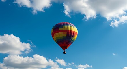 Naklejka premium Hot Air Balloon Ascending in a Summer Sky