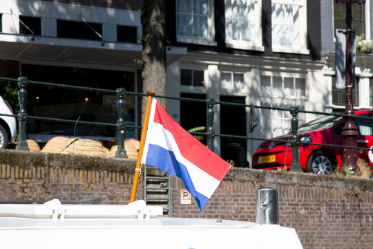 Amsterdam, Netherlands - July 02, 2018: Flag of the Netherlands at the stern of the boat