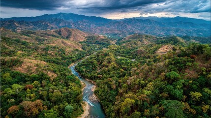 Aerial View Of Winding River Through Lush Valley And Mountains