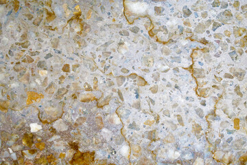 Dirty terrazzo floor with yellow brown stains texture background. Rough and grunge surface.