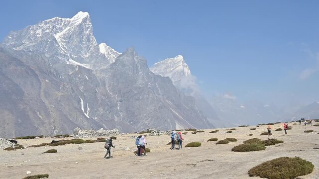 Tourist while trekking to Everest base camp in Nepal with beautiful view of Mt.Cholatse and Mt.Taboche.