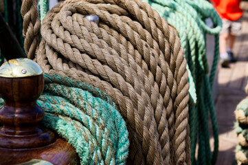 Discover the rugged beauty of nautical equipment with thick, coiled ropes in brown and green on a...