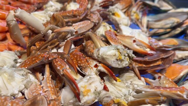 Piled blue crabs show vivid shell textures and natural marine coloration in detailed view
