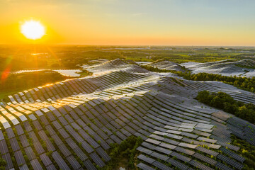 Photovoltaic panels on a hillside at sunset