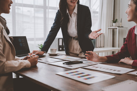 Businesswomen discussing charts and reports in office meeting