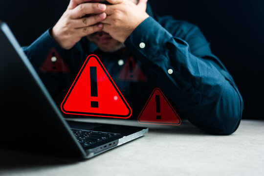 Warning alert system concept. A Man working on the computer, hacked on the computer network, crime and virus, Malicious software, compromised information, illegal connection, data vulnerability,