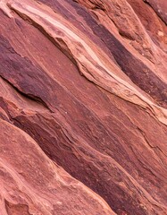Diagonal layers of reddish-brown rock, showing texture and erosion patterns