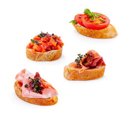 Various delicious bruschetta with toppings on toasted bread slices