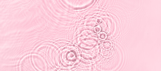 water texture ripples wave clean transparent water abstract background in pink color
