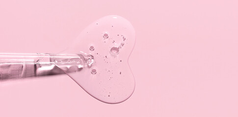 pipette drop of serum test on a pink background