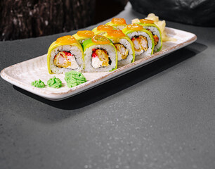 Fresh sushi rolls prepared with vibrant flavors on a sleek plate