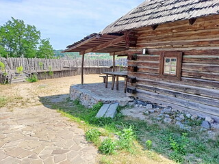 Panorama of a traditional Ukrainian courtyard paved with cobblestones surrounded by a reliable...