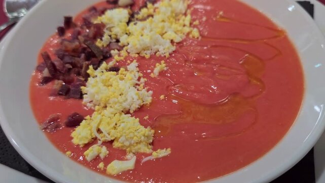 Salmorejo is a traditional Spanish cold tomato soup garnished with serrano ham and boiled egg