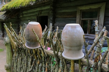 Ceramic pots on the wooden fence