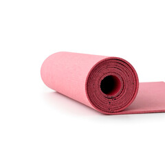 Obraz premium Rolled pink yoga mat on white background 