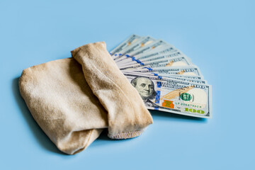 American money dollars hundred dollar bills lie, many bills fan out on a blue background in a...