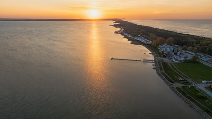 Sunset Over a Lake with Pier and Forested Shoreline