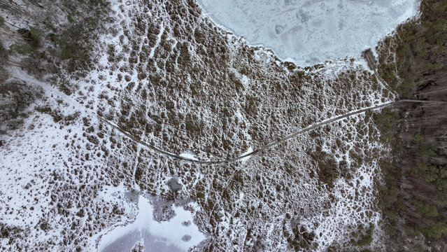 Aerial View of Snow Covered Wetland with Wooden Boardwalk
