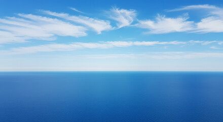 Fototapeta premium Vast Blue Ocean Horizon Under a Cloudy Sky Drone Aerial View