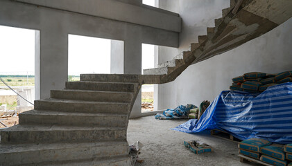 Interior of a new house under construction, cement and concrete staircase
