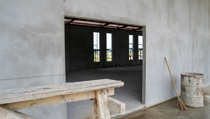 Interior of a room in a new house construction site with a wooden table