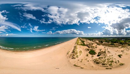 Aerial panoramic view of a sandy beach, ocean, and dunes