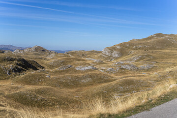 Dry rocky hills under blue summer sky