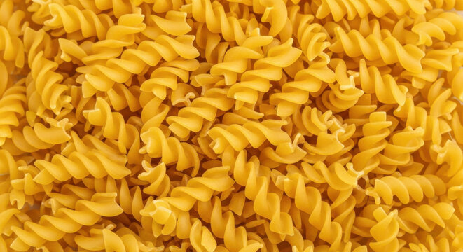 Close-up full frame shot of uncooked fusilli pasta in a bright yellow color - Powered by Adobe