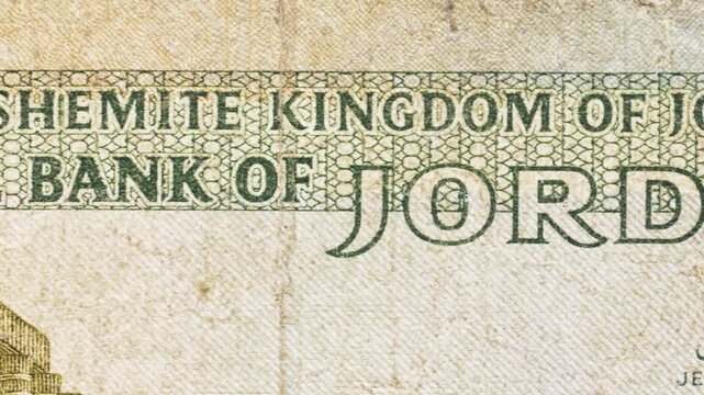 Macro pan over a Jordanian banknote revealing &ldquo;The Hashemite Kingdom&rdquo; and &ldquo;Central Bank of Jordan&rdquo; text