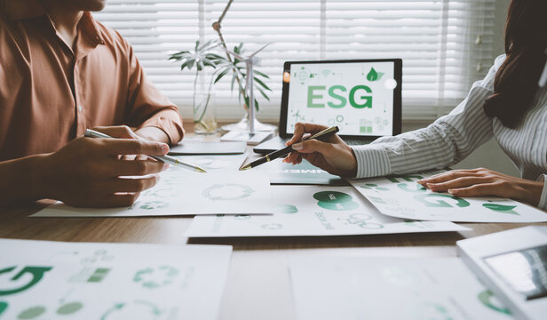 Business people analyzing esg environmental conservation charts