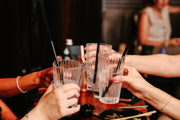 Group of Women Hands Clinking Glasses and Toasting