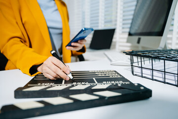 Businesswoman in yellow blazer planning strategy with charts and reports, perfect for corporate,...