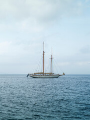 Historic sailing boat at sea with twilight atmosphere