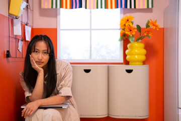 Woman relaxing in colorful home office with laptop and flowers