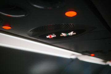 Passenger airplane seatbelt and no smoking signs illuminated