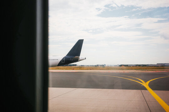 Airplane wing view from airport terminal window