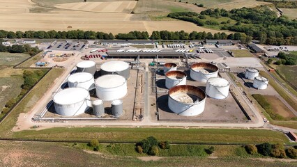 Aerial drone shots of fuel and oil storage silos, industrial petrochemical heavy gas refinery tanks, heavy goods transport in Kingsbury England UK © Liam Carter