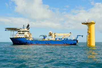 DP3 Cable Laying Vessel Positioned Next to Offshore Wind Turbine Foundation With ROV Deployed