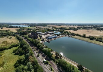 Fototapeta premium Aerial drone shot of wastewater sewage treatment plant, with storage silos and lake water, industrial removal of contaminants in Birmingham England UK