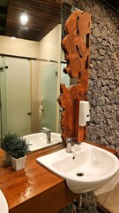 Modern rustic wood wall decor. Natural wood handcrafted at sink and wooden tabletop basin in the...