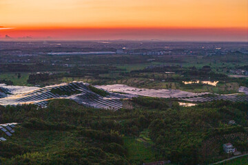 Photovoltaic panels on a hillside at sunset