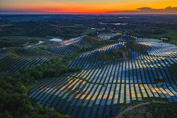 Photovoltaic panels on a hillside at sunset