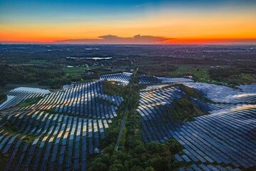 Photovoltaic panels on a hillside at sunset
