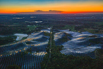 Photovoltaic panels on a hillside at sunset