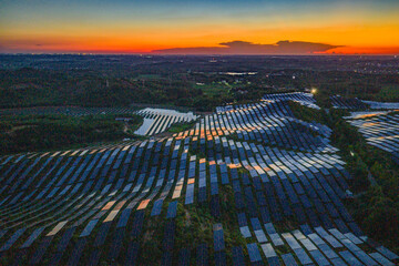 Photovoltaic panels on a hillside at sunset