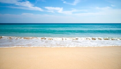 Blurred beach scene with soft waves and a clear sky