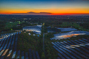 Photovoltaic panels on a hillside at sunset