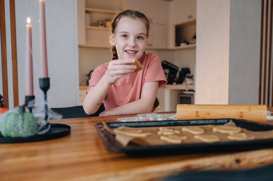Young girl enjoys halloween baking at home
